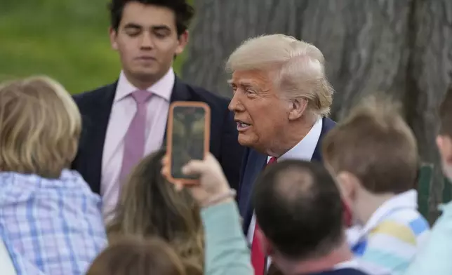 President Donald Trump greets people during the White House Easter Egg Roll on the South Lawn of the White House, Monday, April 21, 2025, in Washington. (AP Photo/Alex Brandon)