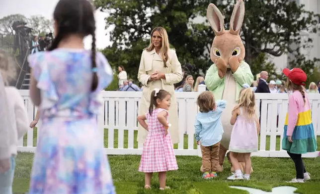 First lady Melania Trump talks with children as they play a game of hopscotch during the White House Easter Egg Roll on the South Lawn of the White House, Monday, April 21, 2025, in Washington. (AP Photo/Mark Schiefelbein)
