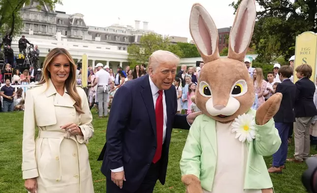 President Donald Trump and first lady Melania Trump, stand with the Easter bunny as they participate in the White House Easter Egg Roll on the South Lawn of the White House, Monday, April 21, 2025, in Washington. (AP Photo/Mark Schiefelbein)