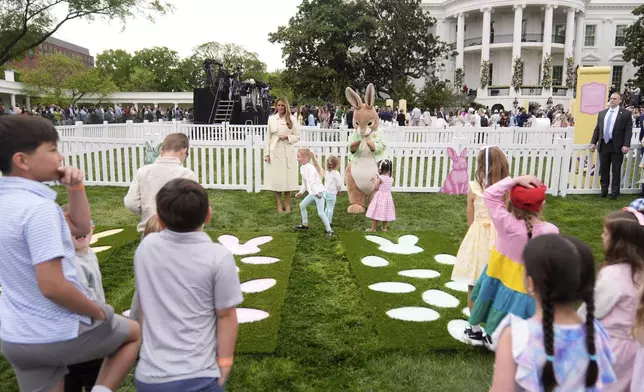 First lady Melania Trump talks with children as they play a game of hopscotch during the White House Easter Egg Roll on the South Lawn of the White House, Monday, April 21, 2025, in Washington. (AP Photo/Mark Schiefelbein)