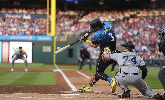 Philadelphia Phillies' Bryce Harper (3) hits a two-run home run off Miami Marlins pitcher Sandy Alcantara during the first inning of a baseball game, Friday, April 18, 2025, in Philadelphia. (AP Photo/Matt Rourke)