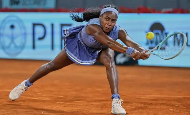 United States' Coco Gauff reaches out to return the ball against Ukraine's Dayana Yastremska during the Madrid Open tennis tournament in Madrid, Spain, Thursday, April 24, 2025. (AP Photo/Manu Fernandez)