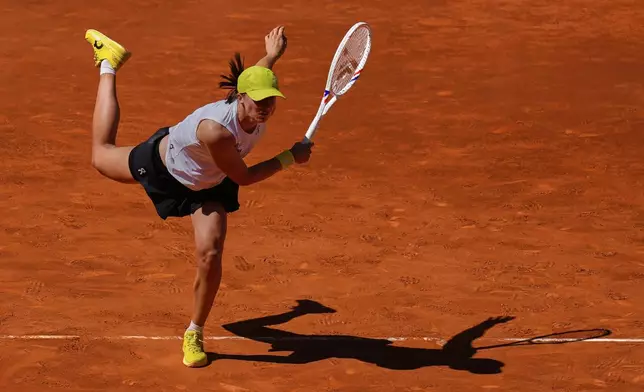 Poland's Iga Swiatek serves against Alexandra Eala of Philippines during the Madrid Open tennis tournament in Madrid, Spain, Thursday, April 24, 2025. (AP Photo/Manu Fernandez)