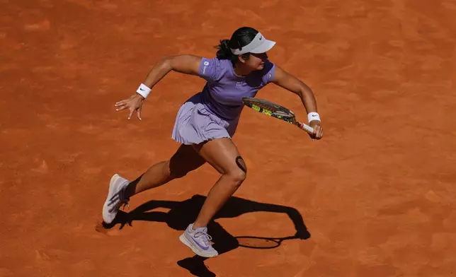 Alexandra Eala of Philippines runs for a ball during her match against Poland's Iga Swiatek during the Madrid Open tennis tournament in Madrid, Spain, Thursday, April 24, 2025. (AP Photo/Manu Fernandez)