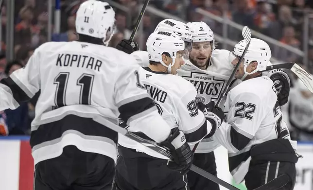 Los Angeles Kings' Adrian Kempe (9) celebrates a goal with teammates against the Edmonton Oilers during first period NHL action in Edmonton, Monday, April 14, 2025. (Jason Franson/The Canadian Press via AP)
