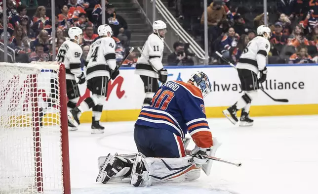 Los Angeles Kings celebrate a goal as Edmonton Oilers goalie Calvin Pickard (30) reacts during the third period of an NHL hockey game in Edmonton, Alberta, Monday, April 14, 2025. (Jason Franson/The Canadian Press via AP)