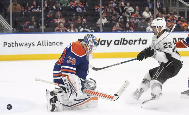 Los Angeles Kings' Kevin Fiala (22) is stopped by Edmonton Oilers goalie Calvin Pickard (30) during the third period of an NHL hockey game in Edmonton, Alberta, Monday, April 14, 2025. (Jason Franson/The Canadian Press via AP)