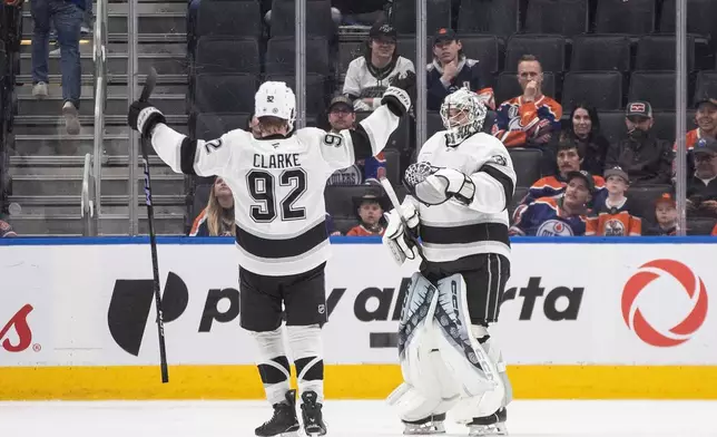 Los Angeles Kings' Brandt Clarke (92) and goalie Darcy Kuemper (35) celebrate a win over the Edmonton Oilers in an NHL hockey game in Edmonton, Alberta, Monday, April 14, 2025. (Jason Franson/The Canadian Press via AP)