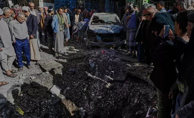 Yemenis watch a hole at Farwah popular market, which Houthis said was struck by U.S. airstrikes, in Sanaa, Yemen, Monday, April 21, 2025. (AP Photo)