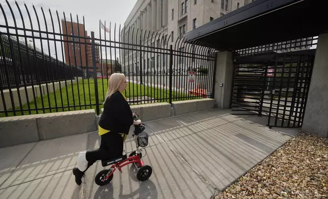 IRS customer service representative Shannon Ellis, goes to work at the processing center where hundreds of her colleagues have taken buyouts and others face potential layoffs, Monday, April 14, 2025, in Kansas City, Mo. (AP Photo/Charlie Riedel)