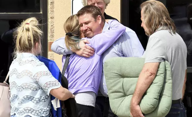 Relatives of murder victim Kristil Krug hug outside of court following the conviction of her husband Daniel Krug in Broomfield, Colo., on Thursday, April 17, 2025. (AP Photo/Thomas Peipert)