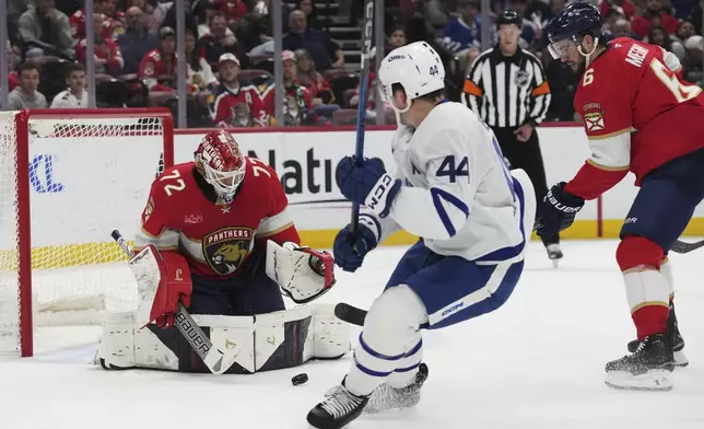 Florida Panthers goaltender Sergei Bobrovsky (72) defends the goal against Toronto Maple Leafs defenseman Morgan Rielly (44) during the first period of an NHL hockey game, Tuesday, April 8, 2025, in Sunrise, Fla. (AP Photo/Lynne Sladky)