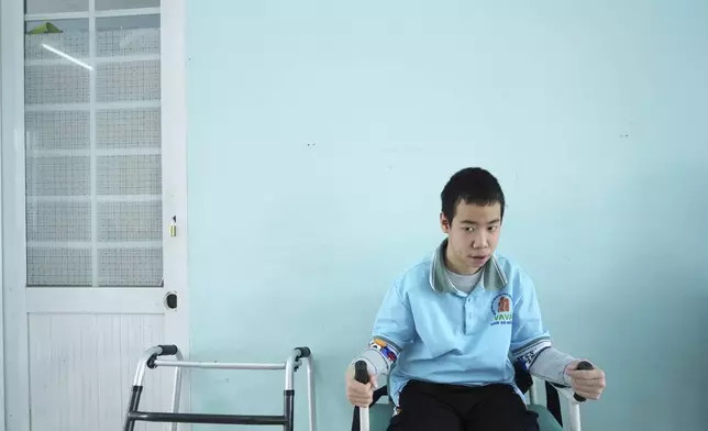 Nguyen Ba Quy Phuoc, 14, attends a physiotherapy class at a school for victims of Agent Orange in Da Nang, Vietnam, March 7, 2025. (AP Photo/Hau Dinh)