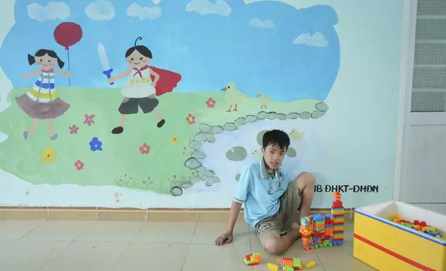 Nguyen Van Quoc Hung, 13, plays with building blocks at a school for victims of Agent Orange in Da Nang, Vietnam, March 7, 2025. (AP Photo/Hau Dinh)