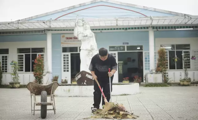 A student sweeps the area in front of a school for victims of Agent Orange in Da Nang, Vietnam, March 7, 2025. (AP Photo/Aniruddha Ghosal)