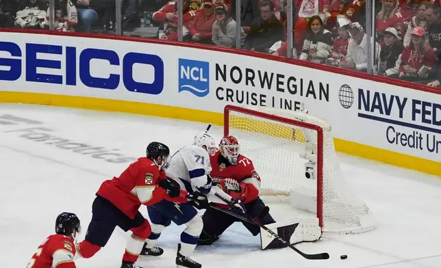 Florida Panthers goaltender Sergei Bobrovsky (72) deflects a shot on goal by Tampa Bay Lightning center Anthony Cirelli (71) during the third period in Game 4 of an NHL hockey Stanley Cup first-round playoff series, Monday, April 28, 2025, in Sunrise, Fla. (AP Photo/Marta Lavandier)
