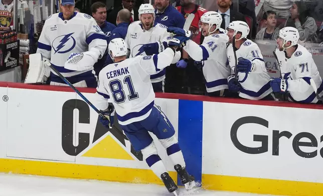 Tampa Bay Lightning defenseman Erik Cernak (81) celebrates his goal with teammates during the second period in Game 4 of an NHL hockey Stanley Cup first-round playoff series against the Florida Panthers, Monday, April 28, 2025, in Sunrise, Fla. (AP Photo/Marta Lavandier)