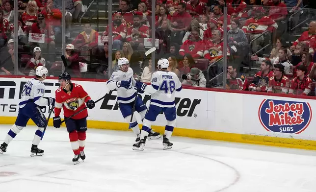 Tampa Bay Lightning right wing Mitchell Chaffee (41) celebrates his goal with defenseman Nick Perbix (48 )during the second period in Game 4 of an NHL hockey Stanley Cup first-round playoff series, Monday, April 28, 2025, in Sunrise, Fla. (AP Photo/Marta Lavandier)