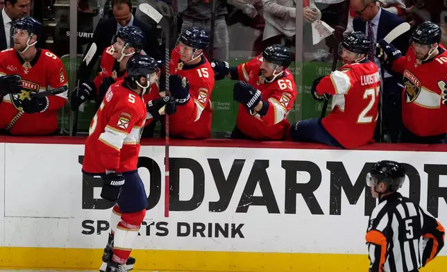 Florida Panthers defenseman Aaron Ekblad (5) celebrates his goal during the third period in Game 4 of an NHL hockey Stanley Cup first-round playoff series against the Tampa Bay Lightning, Monday, April 28, 2025, in Sunrise, Fla. (AP Photo/Marta Lavandier)