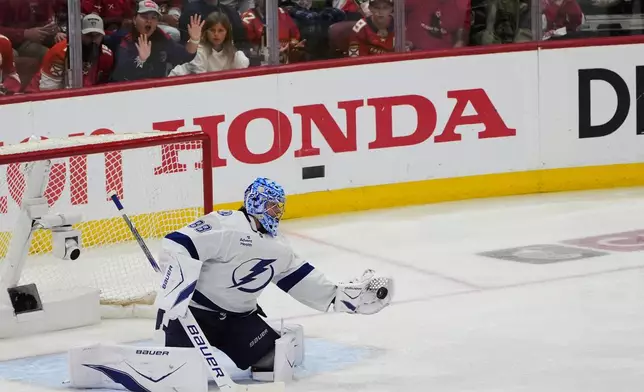 Tampa Bay Lightning goaltender Andrei Vasilevskiy grabs a shot on goal during the third period in Game 4 of an NHL hockey Stanley Cup first-round playoff series against the Florida Panthers, Monday, April 28, 2025, in Sunrise, Fla. (AP Photo/Marta Lavandier)
