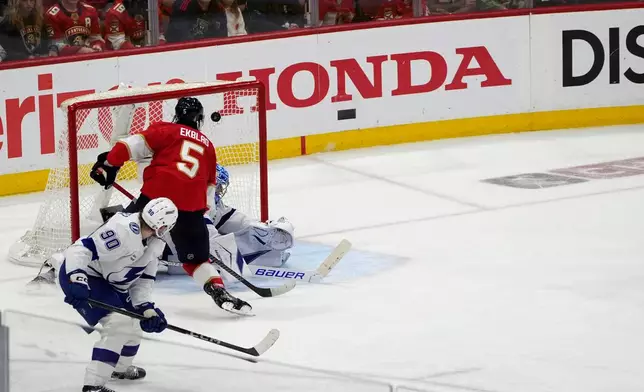 Florida Panthers defenseman Aaron Ekblad (5) scores a goal against Tampa Bay Lightning goaltender Andrei Vasilevskiy (88) during the third period in Game 4 of an NHL hockey Stanley Cup first-round playoff series, Monday, April 28, 2025, in Sunrise, Fla. (AP Photo/Marta Lavandier)