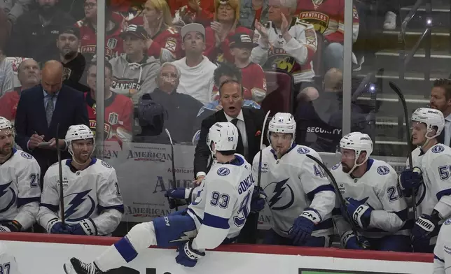 Tampa Bay Lightning head coach Jon Cooper gets center Gage Goncalves (93) on the ice during the first period in Game 4 of an NHL hockey Stanley Cup first-round playoff series against the Florida Panthers, Monday, April 28, 2025, in Sunrise, Fla. (AP Photo/Marta Lavandier)