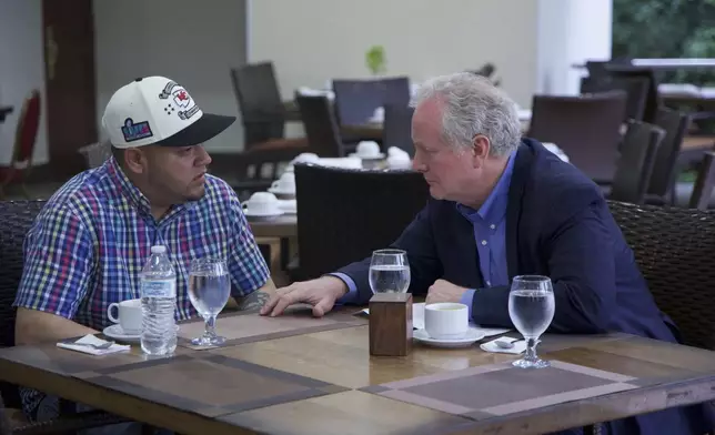 In this photo released by Senator Van Hollen's press office, Hollen, right, speaks with Kilmar Abrego Garcia, a Salvadoran citizen who was living in Maryland and deported to El Salvador by the Trump administration, in a hotel restaurant in San Salvador, El Salvador, Thursday, April 17, 2025. (Press Office Senator Van Hollen, via AP)