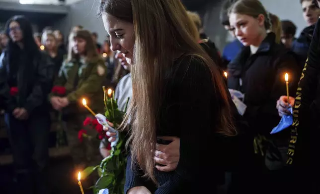 FILE - Alyona Zavadska, 16, cries near the coffin of her boyfriend Danylo Khudia, 17, killed in a Russian strike along with his parents, Viktoria and Oleh Khudia on April 24, during a farewell ceremony at the crematorium in Kyiv, Ukraine, on Monday, April 28, 2025. (AP Photo/Evgeniy Maloletka, File)