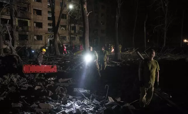Ukrainian servicemen check a destroyed house following a Russian strike at a residential neighbourhood in Kyiv, Ukraine, on Sunday, April 24, 2025. (AP Photo/Evgeniy Maloletka)