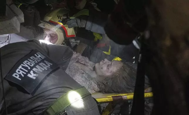 Rescue workers evacuate injured Yana Khudia, 14, from under the rubble of a house destroyed by a Russian airstrike in a residential neighborhood in Kyiv, Ukraine, on Thursday, April 24, 2025. (AP Photo/Evgeniy Maloletka)