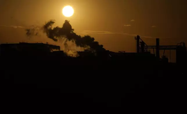 The sun rises behind the JBS meat processing plant, Wednesday, April 16, 2025, in Panhandle, Texas. (AP Photo/Eric Gay)