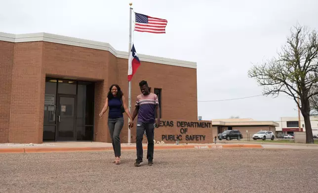 Haitian immigrants Kevenson Jean, a truck driver, and wife Sherlie Jean, a fast food worker, leave the Texas Department of Public Safety, April 14, 2025, in Pampa, Texas. (AP Photo/Eric Gay)