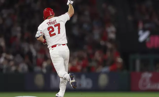 Los Angeles Angels' Mike Trout gestures while rounding the bases after hitting a home run during the sixth inning of a baseball game against the San Francisco Giants in Anaheim, Calif., Saturday, April 19, 2025. (AP Photo/Jessie Alcheh)