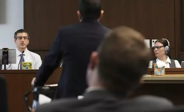 Dr. Jeremy Smiley, left, answers a question from Lake County Assistant State's Attorney Ben Dillon during the sentencing hearing for Robert E. Crimo III., at the Lake County Courthouse, in Waukegan, Ill., Wednesday, April 23, 2025. (AP Photo/Nam Y. Huh, Pool)