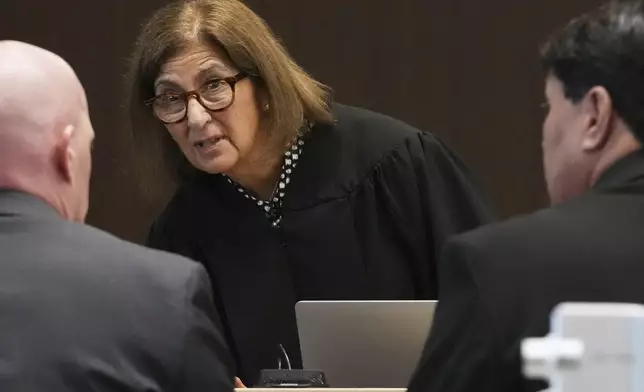 Judge Victoria A. Rossetti, center, talks with Lake County Assistant State's Attorney Ben Dillon, left, and Robert E. Crimo III's attorney Gregory Ticsay during the sentencing hearing for Robert E. Crimo III., at the Lake County Courthouse, in Waukegan, Ill., Wednesday, April 23, 2025. (AP Photo/Nam Y. Huh, Pool)