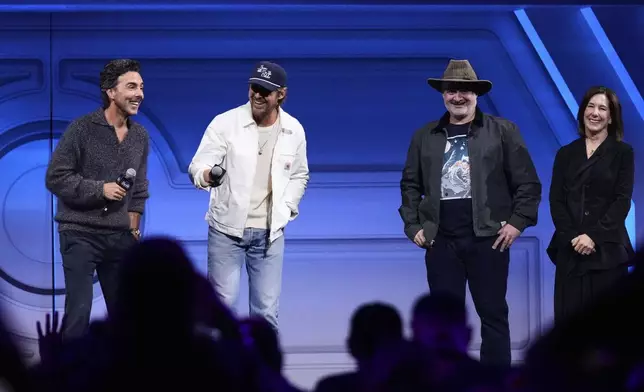 Film director Shawn Levy, left, and actor Ryan Gosling have a light moment on stage with director Dave Filoni and film producer Kathleen Kennedy during a fan convention called the Star Wars Celebration in Chiba, near Tokyo, Friday, April 18, 2025. (AP Photo/Hiro Komae)