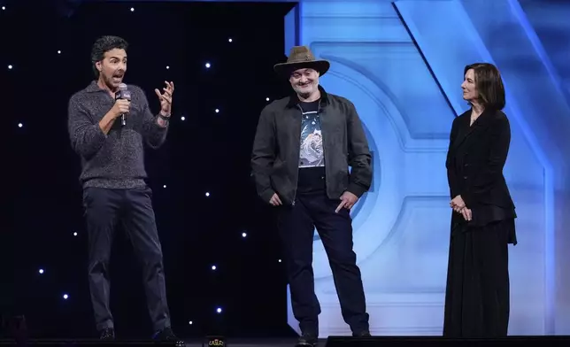 Film director Shawn Levy, left, speaks as director Dave Filoni and producer Kathleen Kennedy listen during a fan convention called the Star Wars Celebration in Chiba, near Tokyo, Friday, April 18, 2025. (AP Photo/Hiro Komae)
