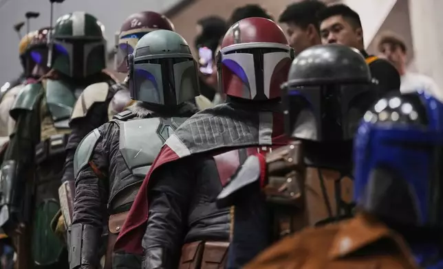 Star Wars fans in different creations of the Boba Fett uniforms attend a fan convention called the Star Wars Celebration in Chiba, near Tokyo, Friday, April 18, 2025. (AP Photo/Hiro Komae)