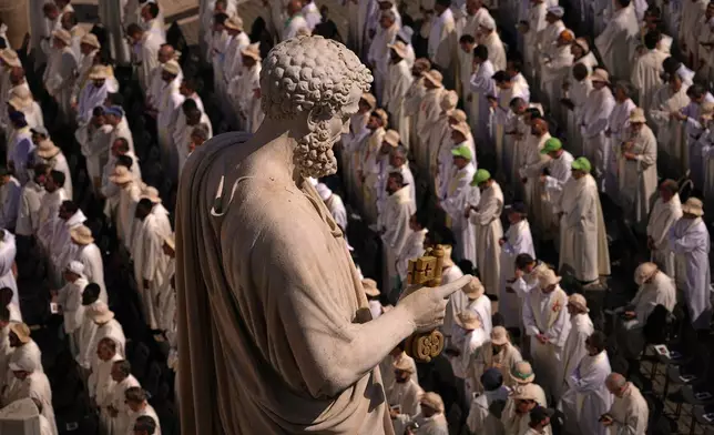 People attend a mass presided over by Vatican Secretary of State, Cardinal Pietro Parolin on the second of nine days of mourning for late Pope Francis in St. Peter's Square, at the Vatican, Sunday, April 27, 2025. (AP Photo/Andreea Alexandru)