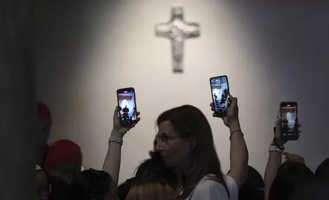 Faithful take photos of the tomb of late Pope Francis inside St. Mary Major Basilica in Rome, Sunday, April 27, 2025. (AP Photo/Andrew Medichini)