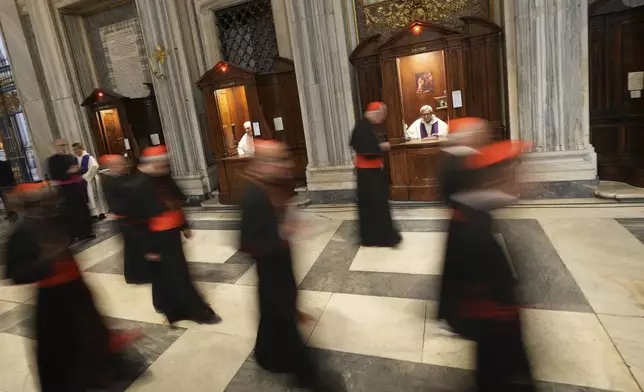 Cardinals walk inside St. Mary Major Basilica, where the late Pope Francis was buried, in Rome, Sunday, April 27, 2025. (AP Photo/Andrew Medichini)