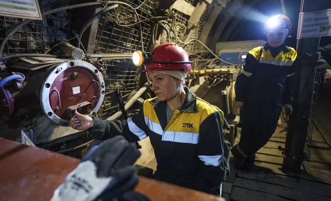 Women work in a tunnel of a coal mine in Dnipropetrovsk region, Ukraine, Jan. 30, 2025. (AP Photo/Evgeniy Maloletka)