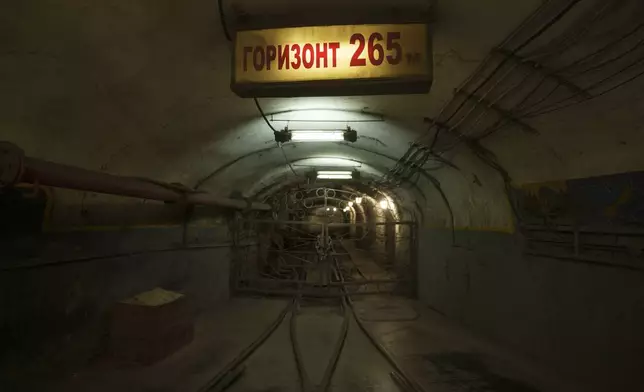 A sign reading "horizon 265 meters underground" hangs in the tunnel of a coal mine in Dnipropetrovsk region, Ukraine, Jan. 30, 2025. (AP Photo/Evgeniy Maloletka)