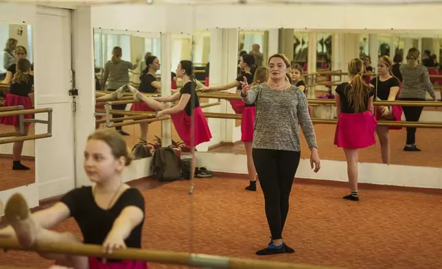 Oksana Polischuk, 51, teaches modern dance at choreography school in Dnipropetrovsk region, Ukraine, Jan. 30, 2025. Originally from Bakhmut, Polischuk, lost her husband on a war, she became an IDP in Poland. She decided to return to Ukraine and be useful for her country working on a coal mine underground. (AP Photo/Evgeniy Maloletka)