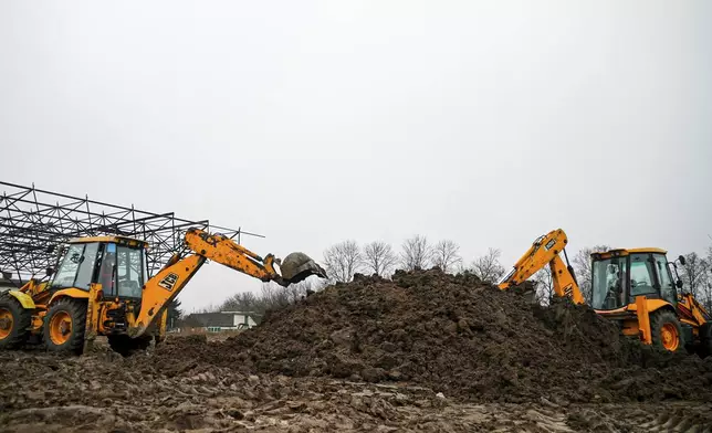 In this image taken from video, women operate excavators during construction work in Nemishaieve, Kyiv region, Ukraine, Dec. 27, 2024. (AP Photo/Vasilisa Stepanenko)