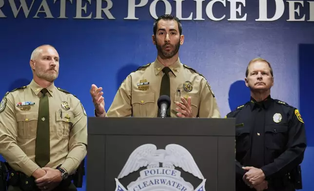 Matthew Dallarosa, center, of the Florida Fish and Wildlife Conservation Commission, flanked by Evan Laskowski, left, also of FWC, and Clearwater, Fla., Police Chief Eric Gandy, right, speaks during a news conference Monday, April 28, 2025, in Clearwater, Fla., after a deadly boating accident Sunday night. (AP Photo/Chris O'Meara)