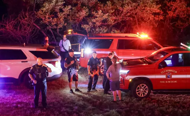 First responders gather on a beach near where a boat crashed into the ferry causing multiple injuries near the Clearwater Memorial Causeway Bridge, on Sunday, April 27, 2025, in Clearwater, Fla. (Douglas R. Clifford/Tampa Bay Times via AP)