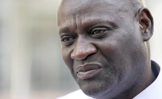 Demba Dem, a former member of the Gambian parliament who was tortured by former Gambian military member Michael Sang Correa, stands outside federal court following Correa's conviction in Denver on Tuesday, April 15, 2025. (AP Photo/Thomas Peipert)