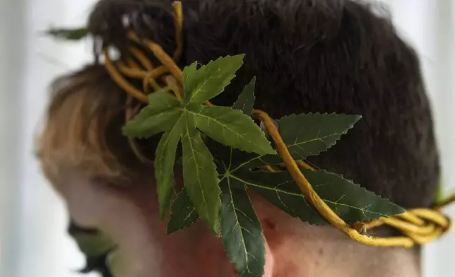 Drag performer Ed De'Bull wears a crown with faux marijuana leaves during a "blaze and praise" drag brunch at Bar Carlo on Sunday, April 20, 2025, in Portland, Ore. (AP Photo/Jenny Kane)