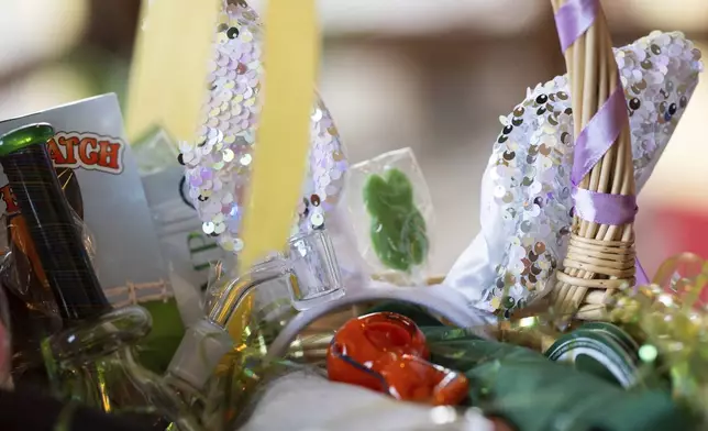 A glass pipe is seen in an Easter giveaway basket during a "blaze and praise" drag brunch at Bar Carlo on Sunday, April 20, 2025, in Portland, Ore. (AP Photo/Jenny Kane)